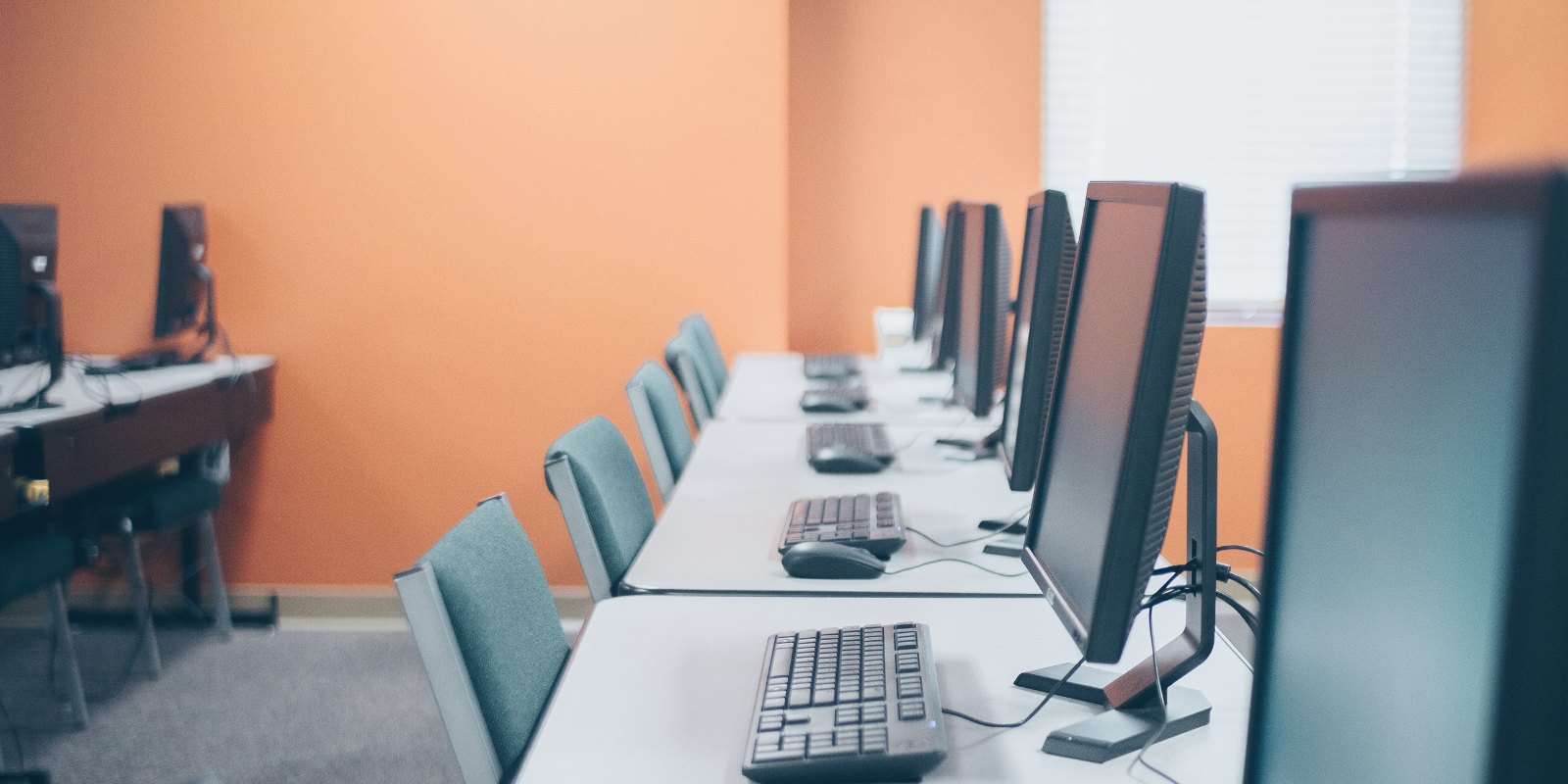 A computer training room with rows of desks and monitors